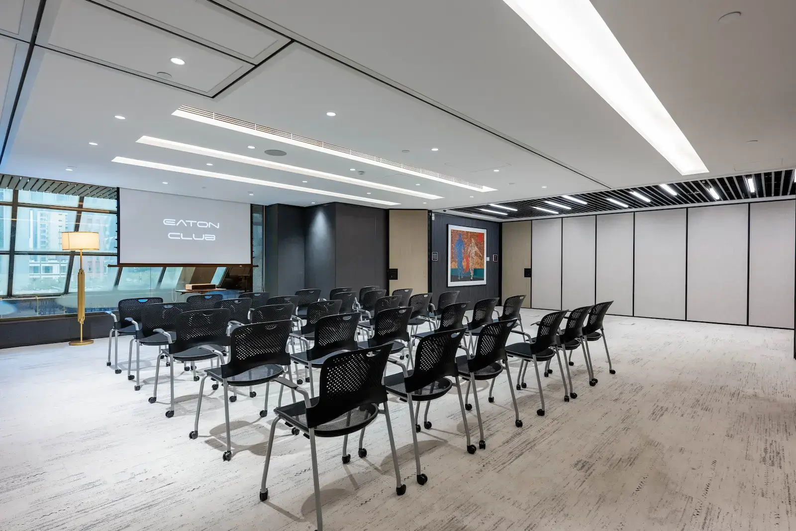 Eaton Club Wan Chai event venue with theatre-style seating and a projector screen.